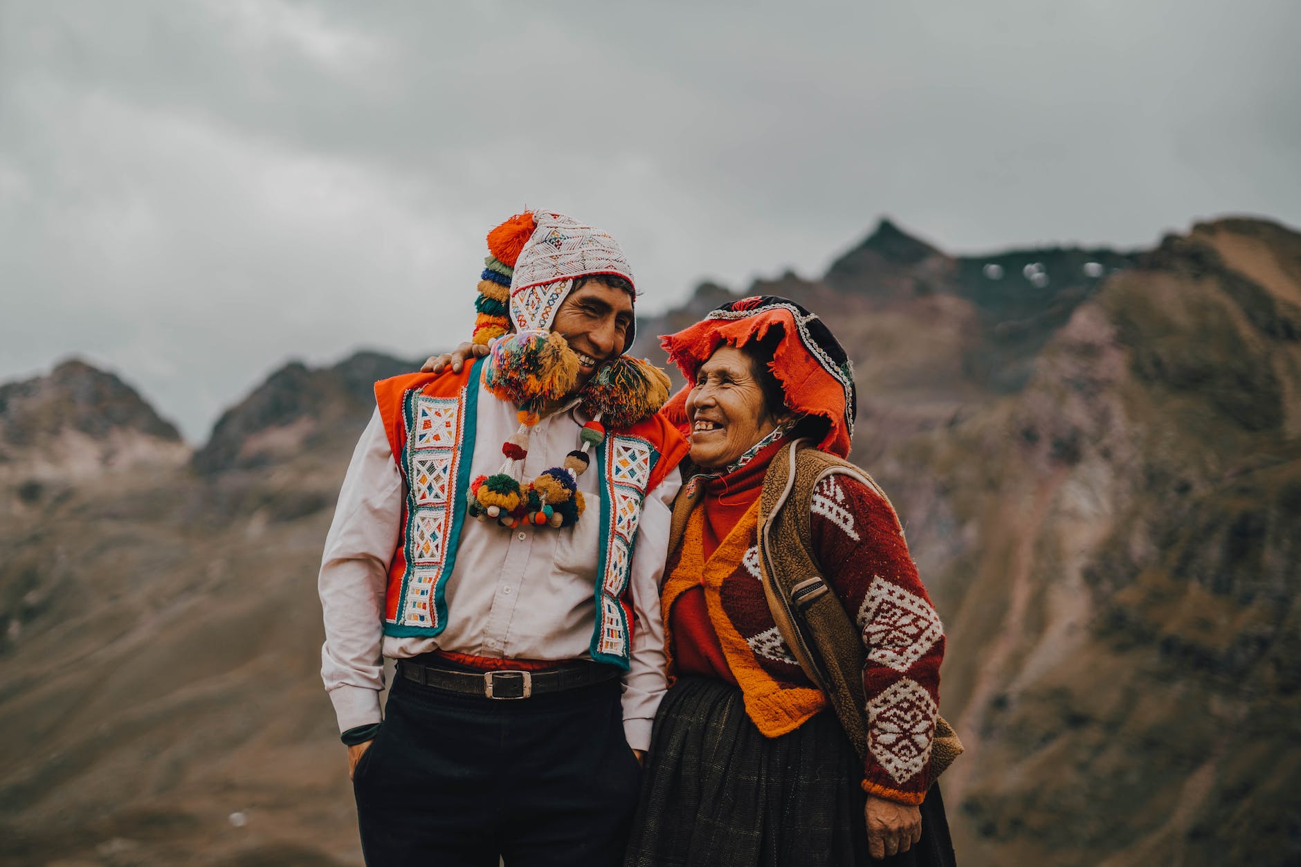 man and woman in traditional clothing looking at each other and smiling