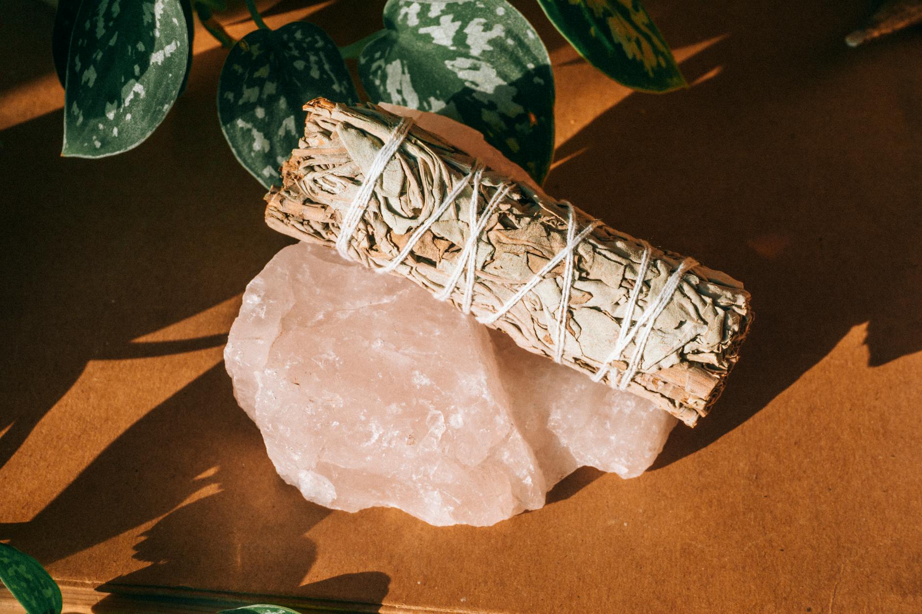 bundle of pressed herbs on a rose quartz